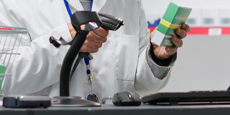 pharmacist scanning medication with bar code scanner